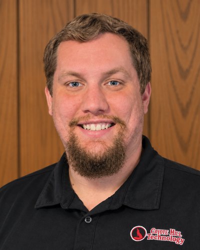 Jarrett Floss, founder of Coyote Hill Technology, in a company work shirt